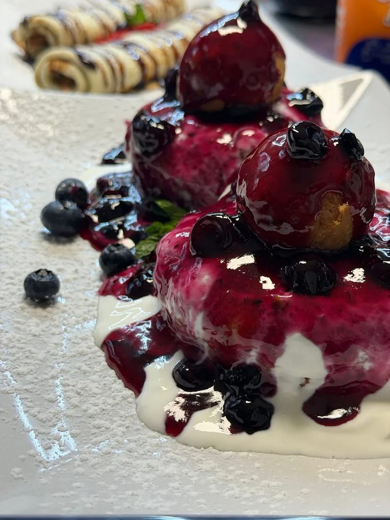Papanași, Romanian doughnuts with blueberry sauce and soured cream at Restaurant Acasă