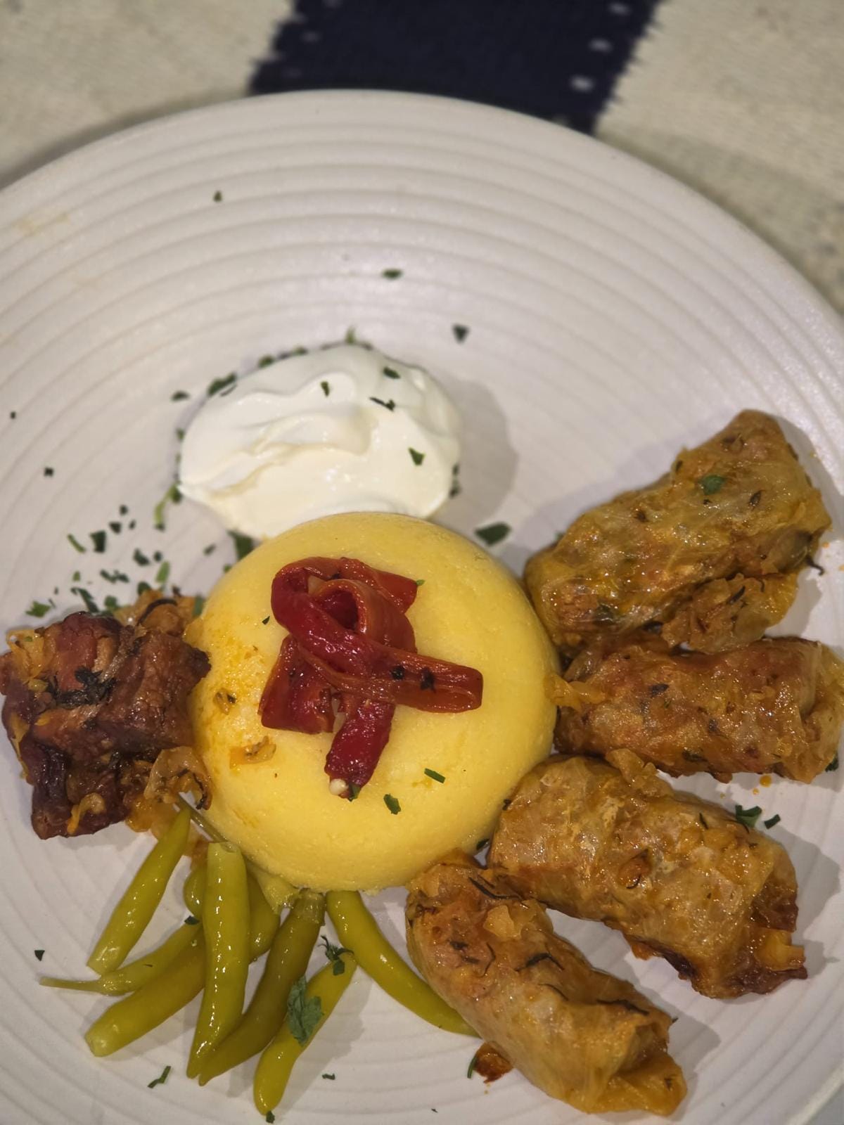 Sarmale, cabbage rolls with polenta, soured cream and roasted pepper at Restaurant Acasă