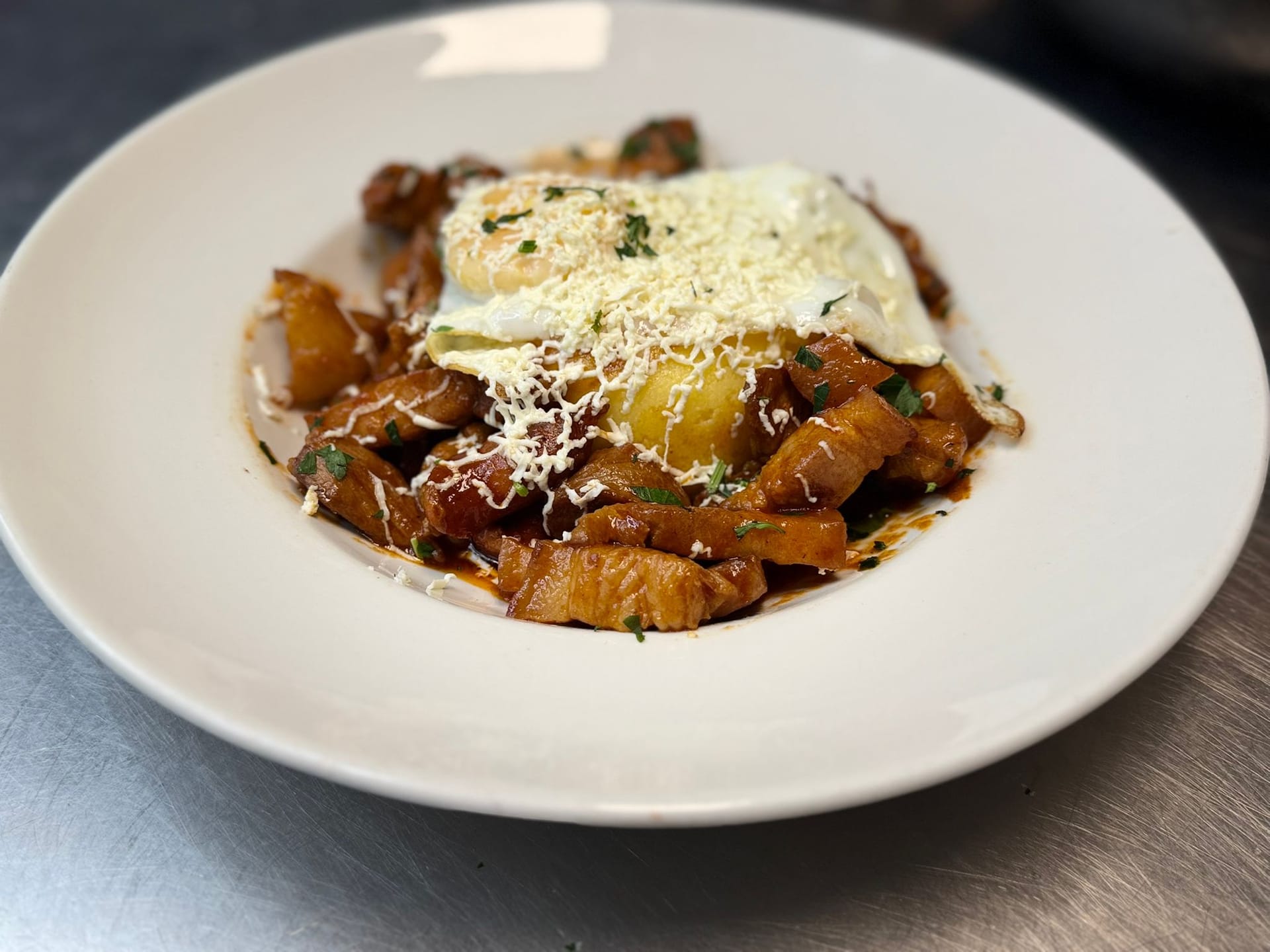 Tochitură, pork in sauce with polenta and a fried egg at Restaurant Acasă