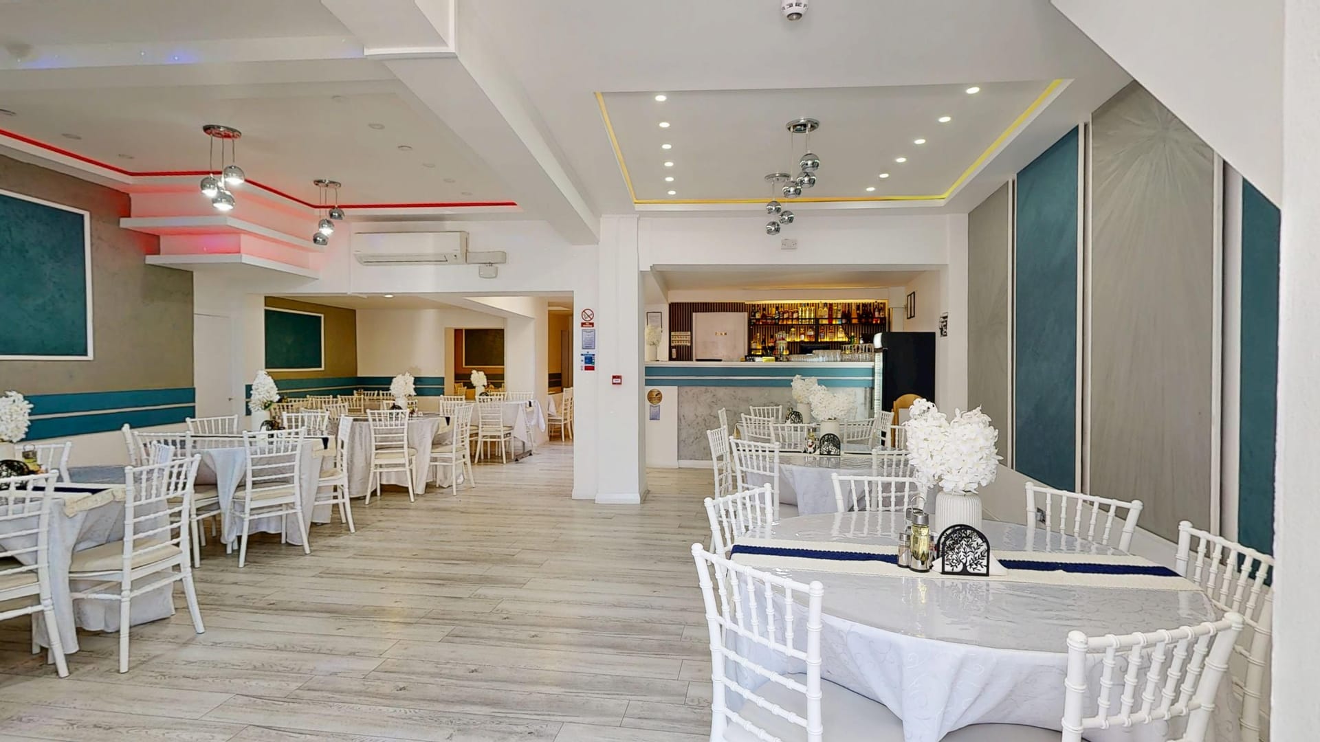 Dining room at Restaurant Acasă with white linen tables and Chiavari chairs